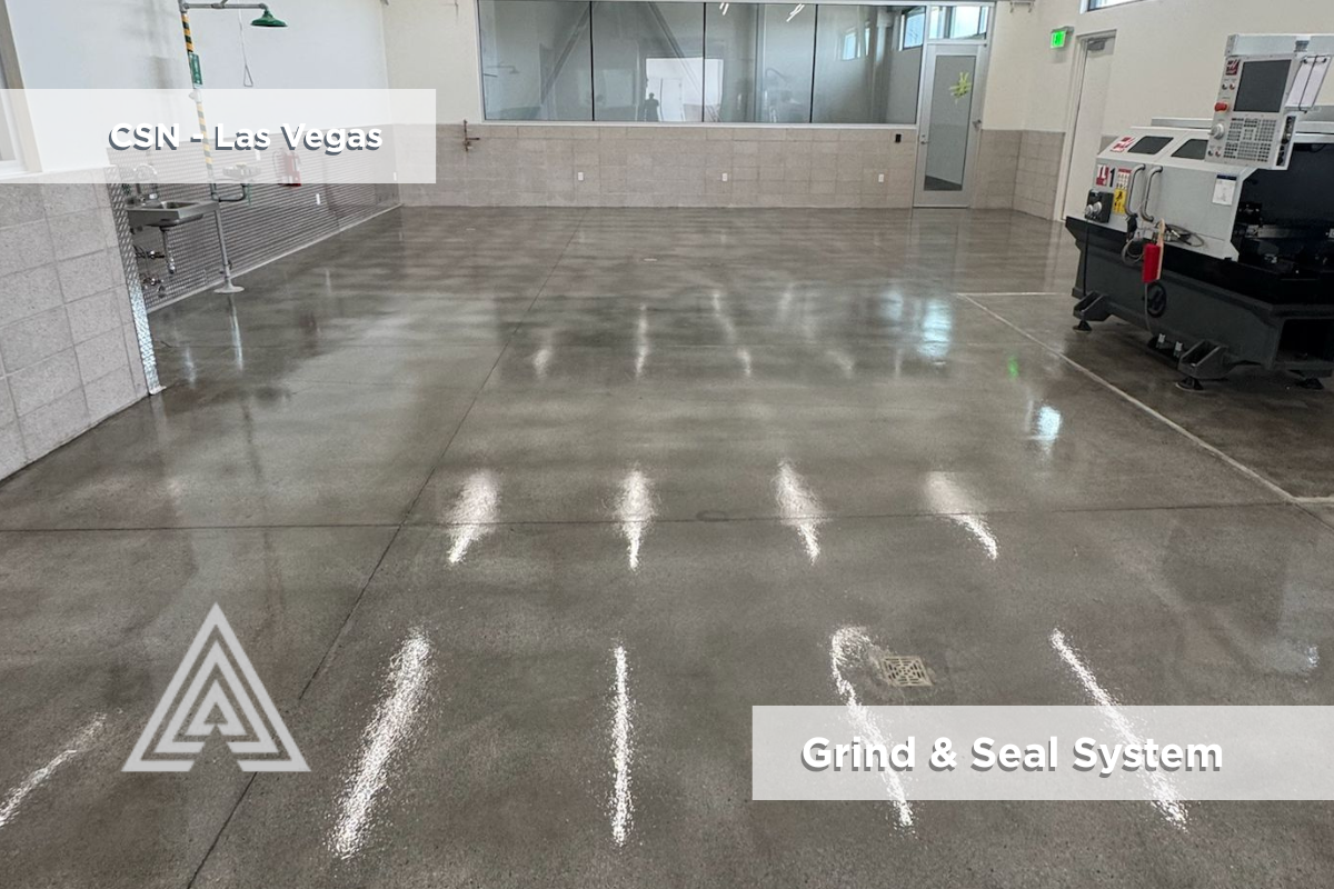Finished grind & seal concrete floor under industrial lighting