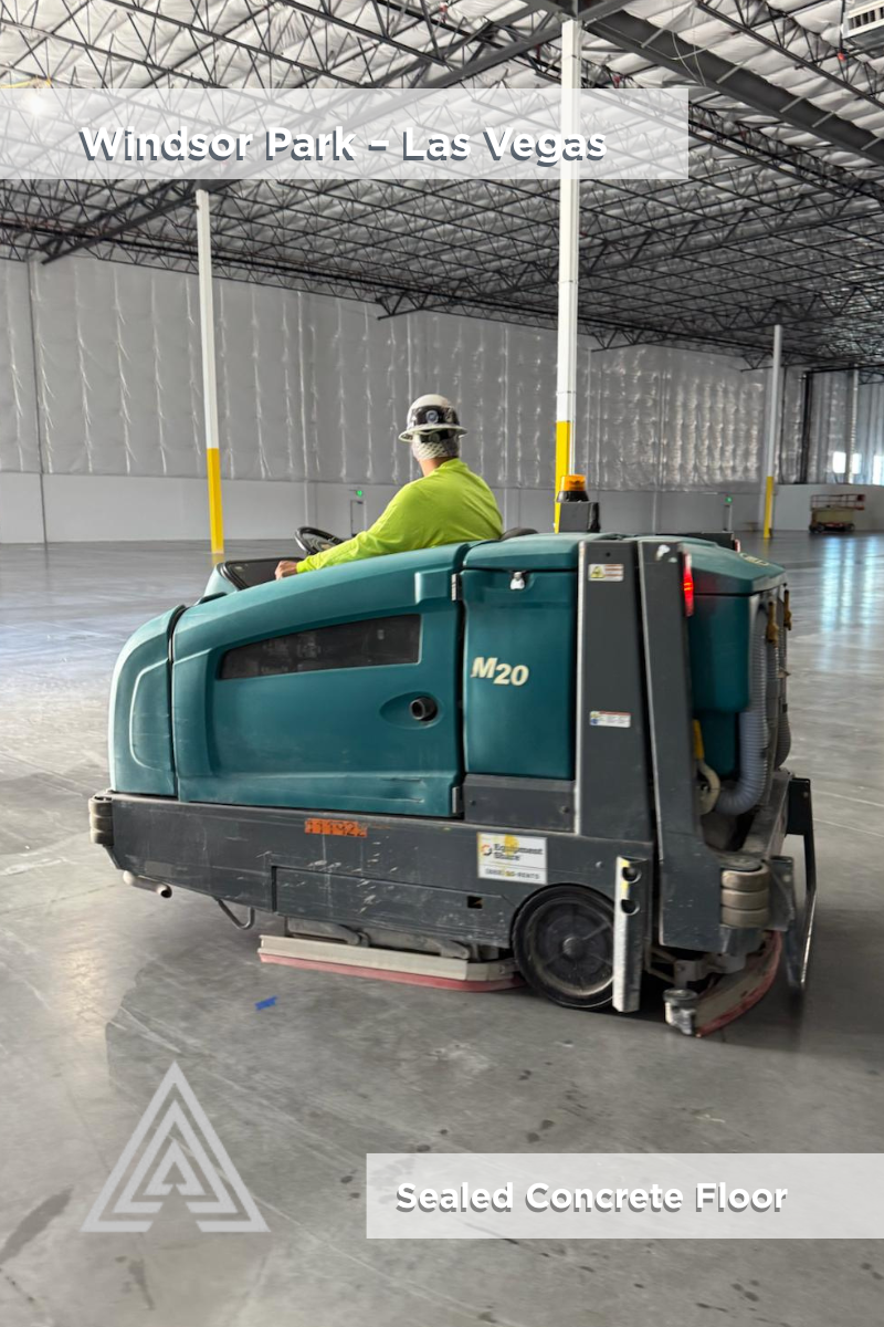 Warehouse interior with sealed gray concrete slab and structural columns